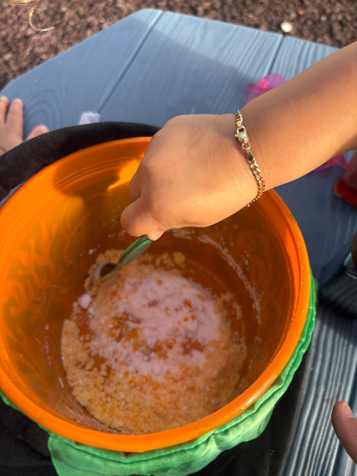 Close-up of child stirring potion