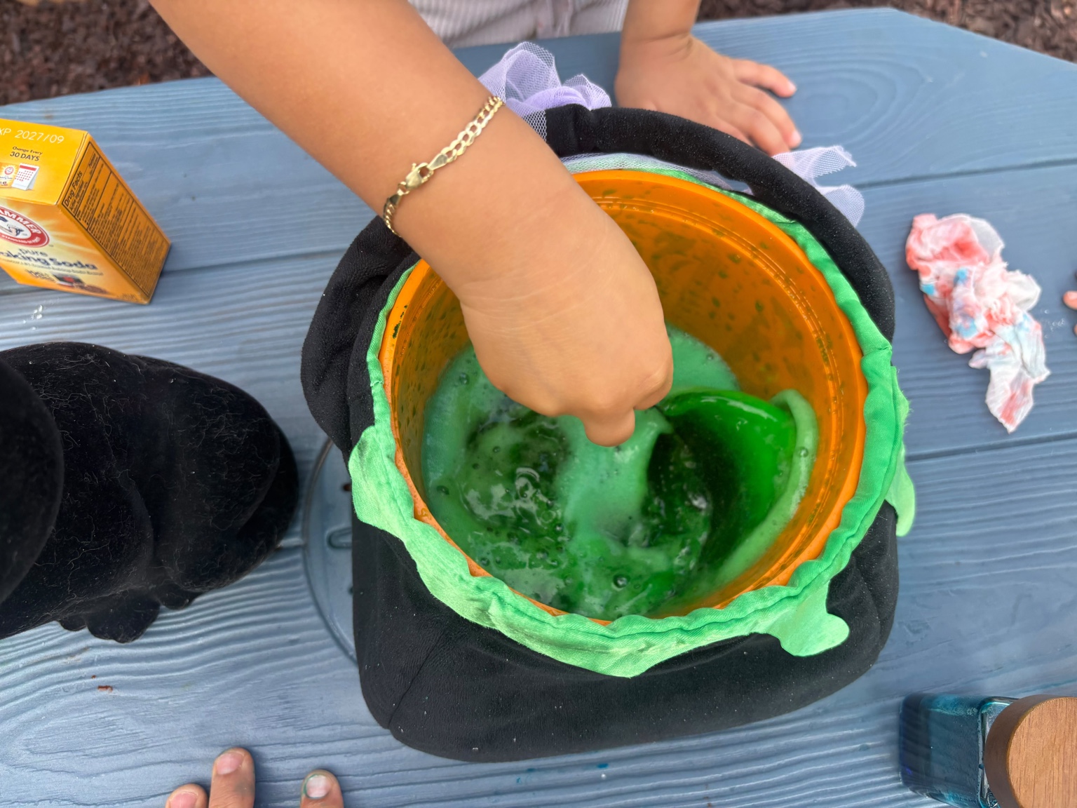 Child stirring green foaming mixture