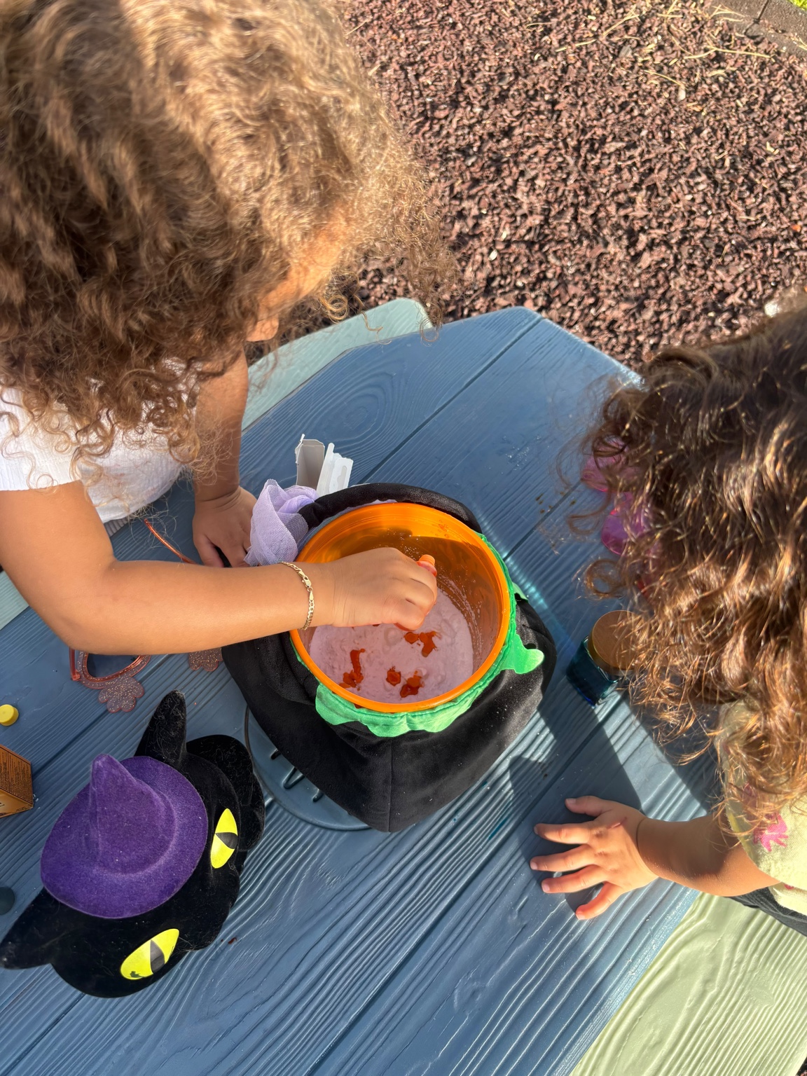 Two children exploring cauldron experiment together